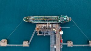 Aerial view oil tanker ship oil depot terminal storage petroleum petrochemical refinery product.