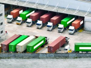 Freight trucks at warehouse loading dock. Industry logistics and distribution center. Logistics